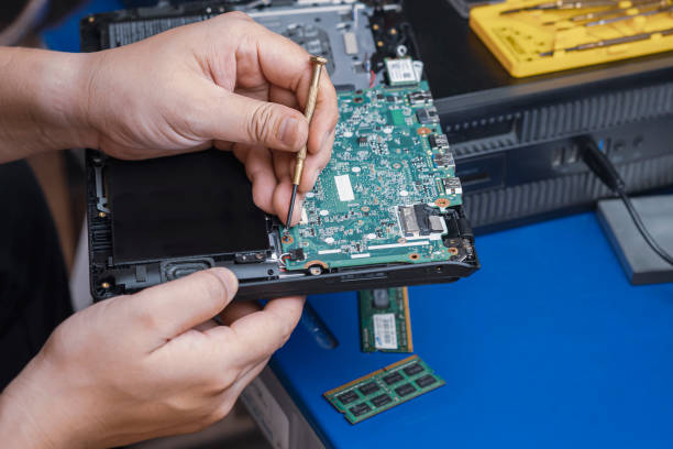 istock Technician's hand using screwdriver to assembling the motherboard of laptop computer on desk at workshop 1366075780
