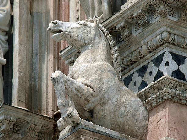 Architectural details of Duomo facade - Siena,Tuscany,Italy. The Duomo of Siena, which was built in the 12th and 13th centuries, is one of the prettiest churches in Gothic style in Italy