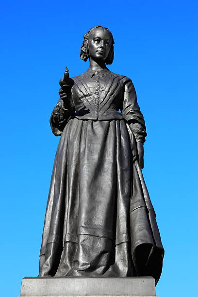 Florence Nightingale Statue A bronze memorial statue of Florence Nightingale in Waterloo Place, Westminster, London, by Arthur Walker (1861-1939) which was unveiled in Waterloo Place in 1915. Florence Nightingale was an English nurse known as 'the Lady With The lamp', who cared for wounded soldiers in the Crimean War. old oil lamp stock pictures, royalty-free photos & images