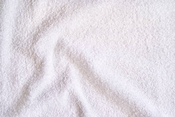 White towel texture. Fluffy carpet background. Blank bathroom textile. Warm sweater material. Soft baby fabric. Grey flat surface. Home expensive design