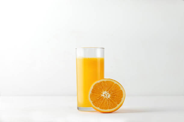 istock Glass with orange juice and fresh fruit on white table for menu and mock up. Easy isolated. 1366077730