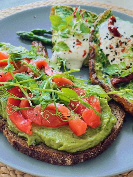 istock Scrambled eggs with spinach, sour cream and guacamole salmon toast 1366080965