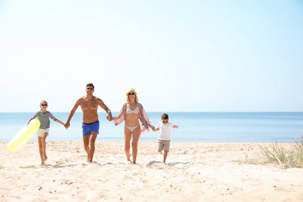 istock Family with inflatable ring at beach on sunny day 1366081010