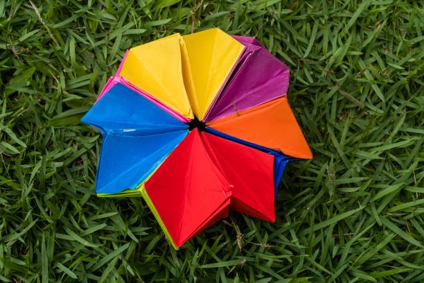istock Colored paper origami over garden grass. 1366081135