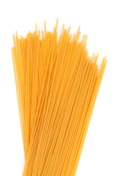 istock Bright yellow noodles closeup isolated on white 1366083305