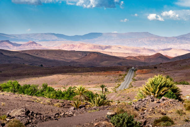 The N10 road in Morocco. The road goes towards a desert mountain landscape morocco landscape stock pictures, royalty-free photos & images