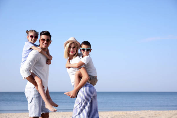 istock Happy family at beach on sunny day 1366084842