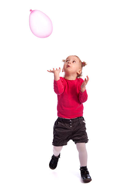 istock little girl playing with a balloon 136608624