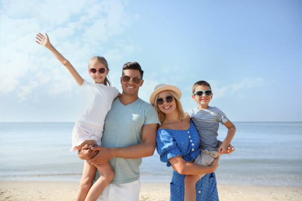 istock Happy family at beach on sunny summer day 1366087029