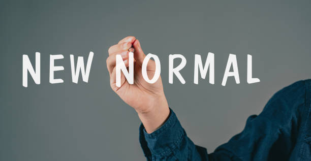 istock Young man writes the words new normal, post covid-19 pandemic, changing lifestyle, different life, beginning transformation 1366089549