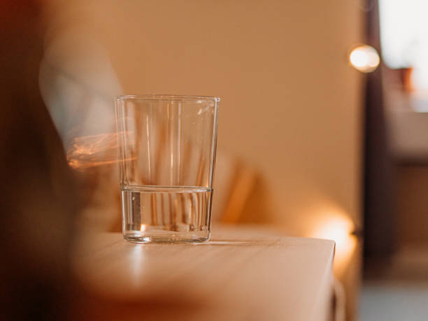 istock Glass of water on table with bokeh 1366089720