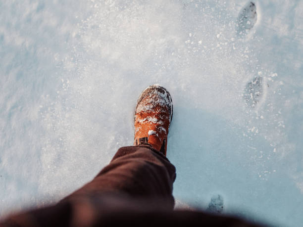 istock Walking in snow with winter boot personal perspective 1366089826