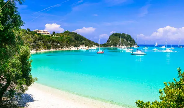 Photo of Beautiful turquoise bay in Lakka. splendid beach Paxos. Ionian islands of Greece