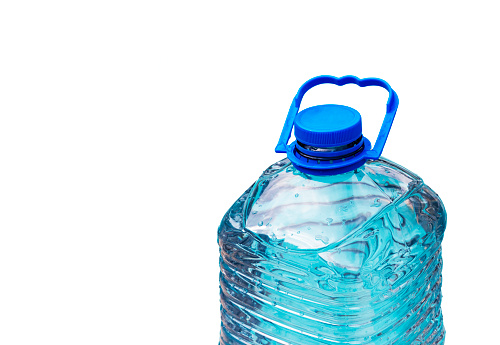 Plastic water bottle, 5 liter, with water drops isolated on white background. Space for text.