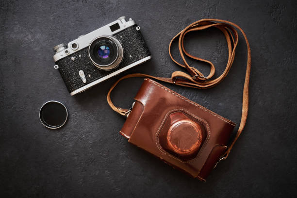 istock Old shabby retro camera and leather carrying case 1366094653