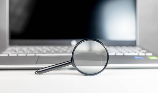 istock Laptop through magnifying lens. Internet search and SEO research concept 1366095795