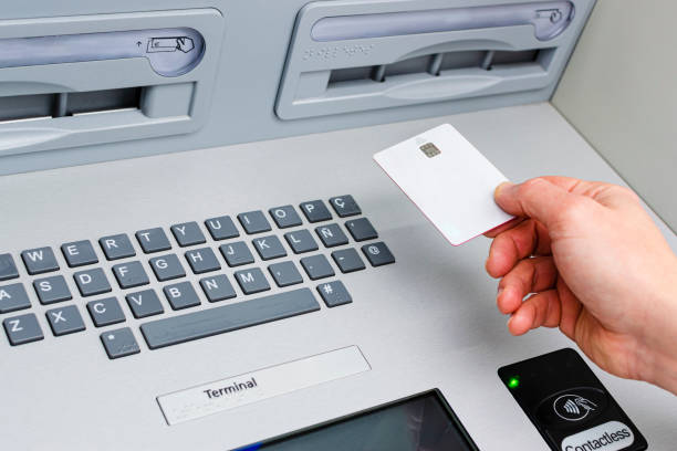 istock A man using a credit card at a contactless ATM. 1366096296