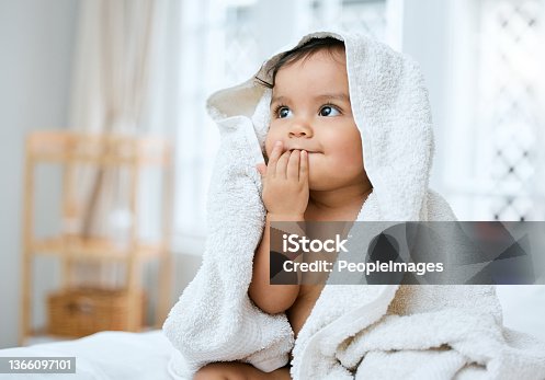 istock Shot of an adorable baby covered in a towel after bath time 1366097101