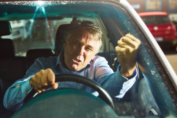 istock Angry middle-aged man expresses his road rage with an aggressive gesture 1366097810