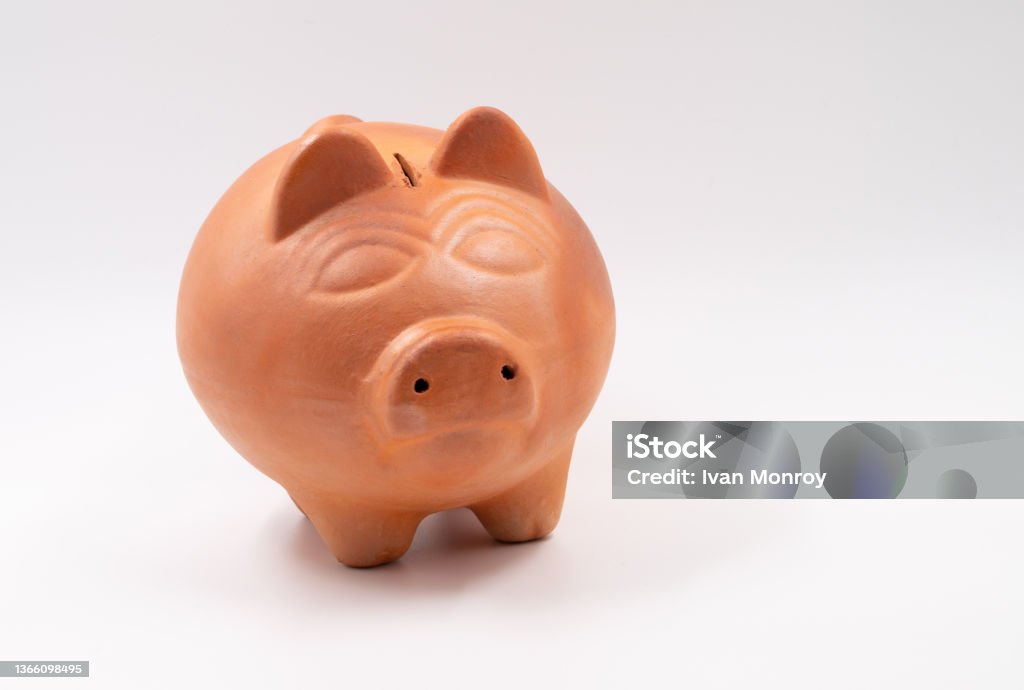 The clay piggy bank. The piggy bank as a method of saving. Bank - Financial Building Stock Photo