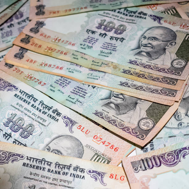 istock Old One Hundred Rupee notes combined on the table, India money on the rotating table. Old Indian Currency notes on a rotating table, Indian Currency on the table 1366100274