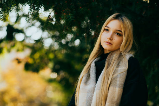 istock young girl autumn portrait 1366101504