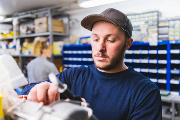 Automobile Engineer working in a Garage Pair of Automobile engineers working in the R&D center minimum wage stock pictures, royalty-free photos & images