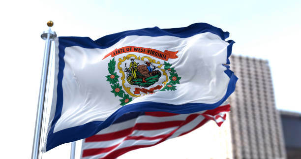 the flag of the US state of West Virginia waving in the wind the flag of the US state of New Mexico waving in the wind with the American flag blurred in the background. West Virginia was admitted to the Union on June 20, 1863 as 35th state west virginia us state stock pictures, royalty-free photos & images