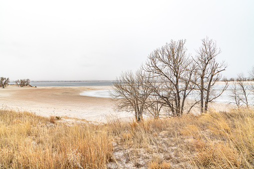 Sandy beaches at wnter at summer recreation area is dreary with snow and cold in southern Nebraska at Lake McConaughy at Ogallala in central United States of America (USA)