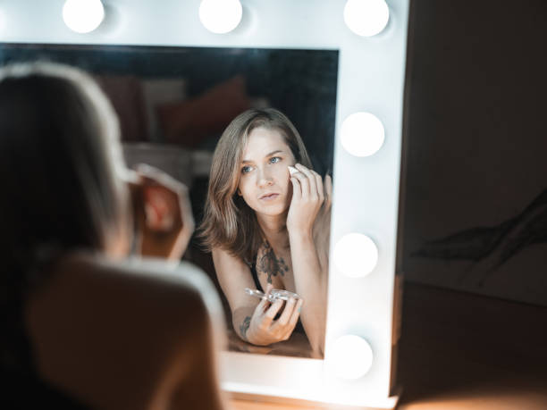 istock Young Caucasian woman doing make up in her apartment 1366109329