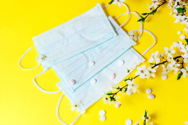 istock Spring flowers with medical protective mask, allergy concept 1366114462