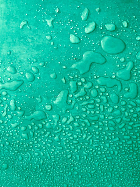 water drops of different sizes on a green surface, drops texture, rain on green tile, rain texture, refreshing nature background water drops of different sizes on a green surface, drops texture, rain on green tile, rain texture, refreshing nature background, vertical humidity photos stock pictures, royalty-free photos & images