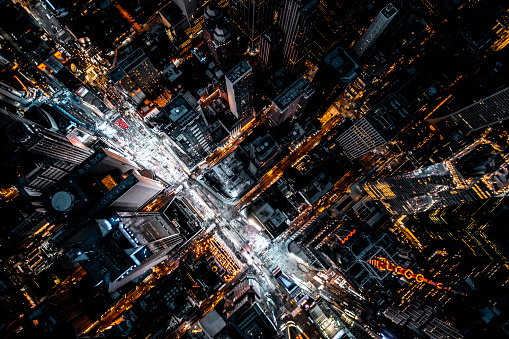 Aerial view directly from above on famous Time Square in New York seen during the night with all shining lights and vibrant colours and photographed from a helicopter.