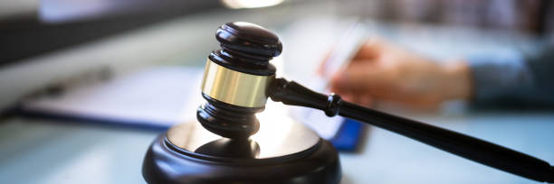 istock Cropped Image Of Female Judge Signing Document 1366117064