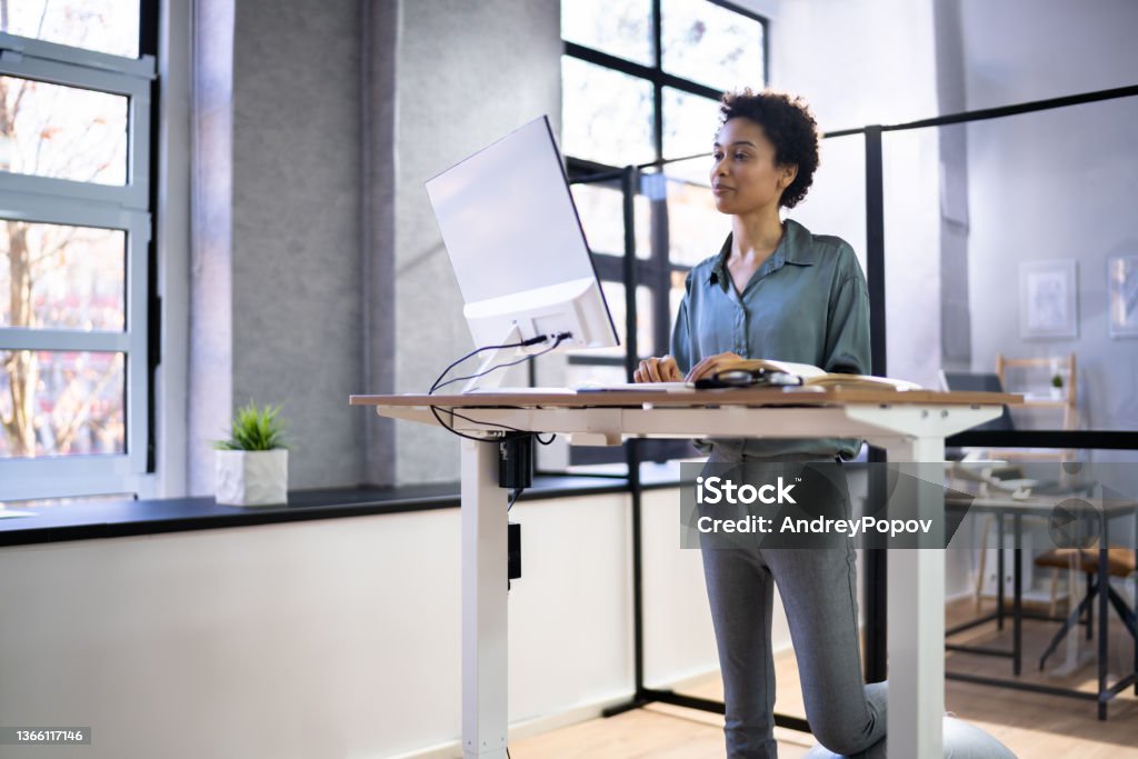 Adjustable Height Desk Stand In Office Adjustable Height Desk Stand In Office Using Computer Adjustable Stock Photo