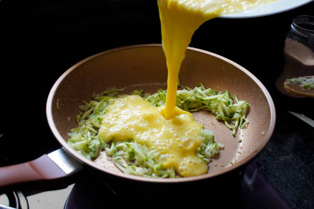 Preparing an omelet with zucchini and cheese. Homemade and organic food stock photo