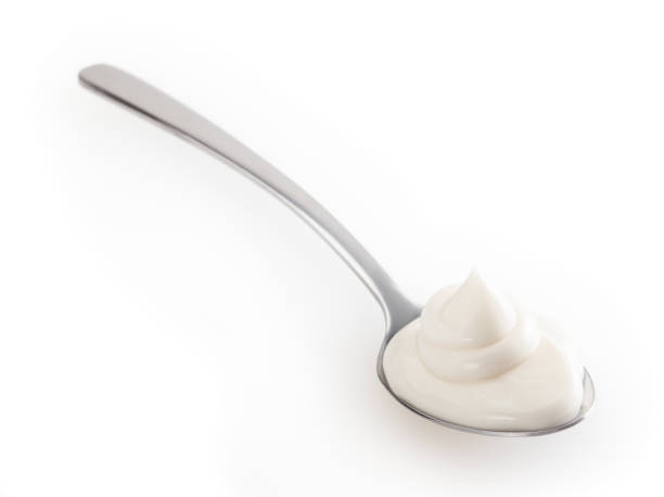 istock Spoon of mayonnaise isolated on white background with clipping path 1366118675