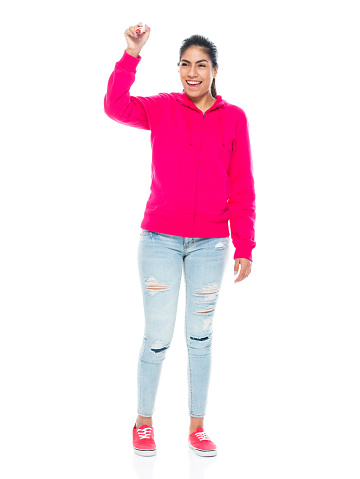 Full length of aged 20-29 years old who is beautiful with black hair generation z young women teacher standing in front of white background wearing canvas shoe who is smiling who is writing and using pen