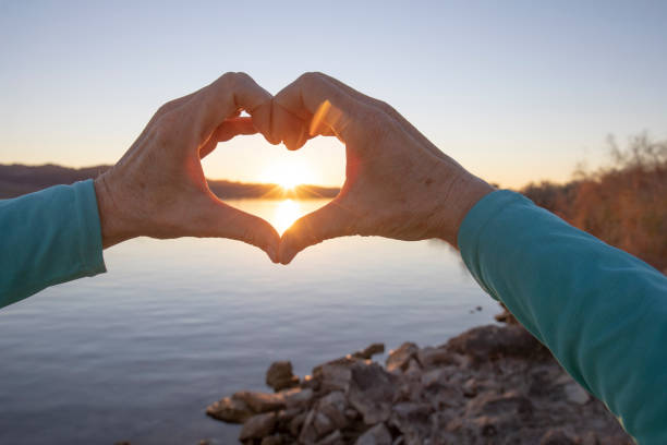 istock View of woman's hands making heart shape 1366125188