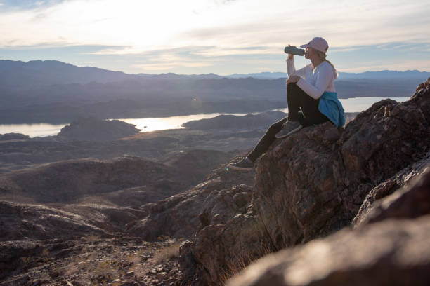 istock Female hiker relaxes on sunny mountain ridge 1366125327