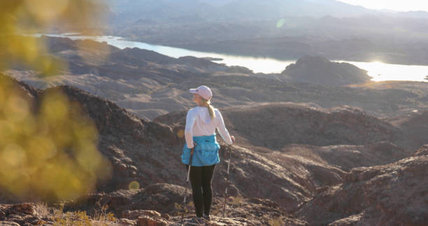 istock Woman hikes through sunny desert landscape 1366125348