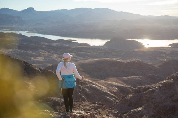 istock Woman hikes through sunny desert landscape 1366125350