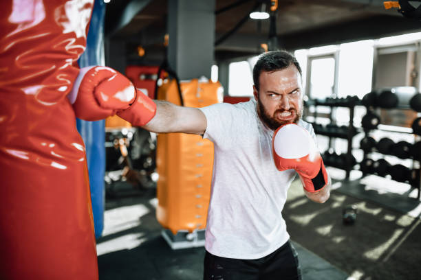 istock Tough Male Boxing On Heavy Bag 1366126150