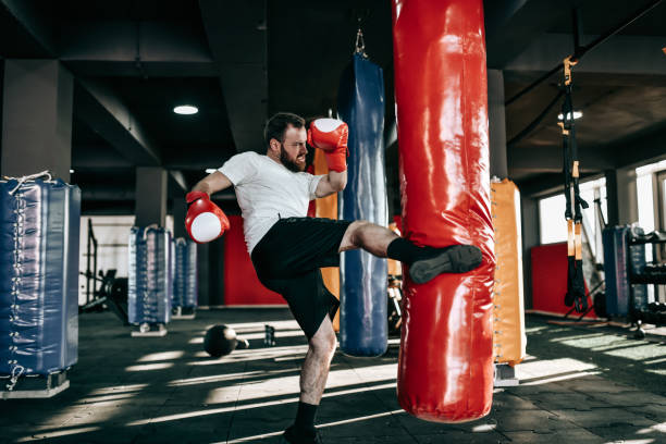istock Male Kickboxer Working On Leg Kicks With Heavy Bag 1366126275