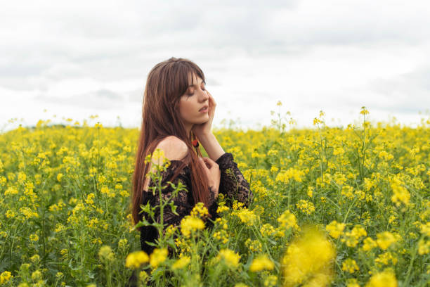 istock Young woman in spring field 1366126521