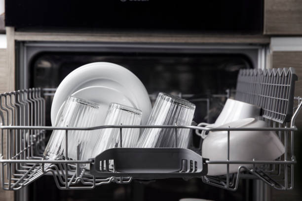 istock Open dishwasher with clean utensil inside, cutlery, glasses, dishes at kitchen 1366127077