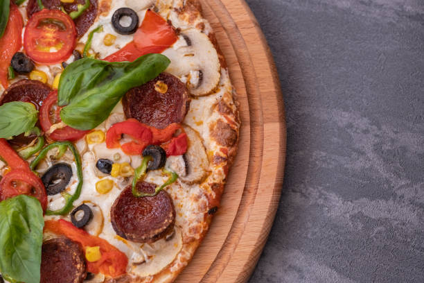 istock Pepperoni pizza with salami, basil and red pepper 1366129005