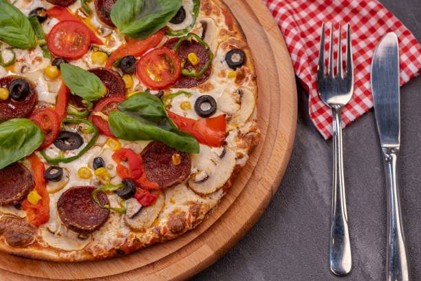 istock Pepperoni pizza with salami, basil and red pepper 1366129047