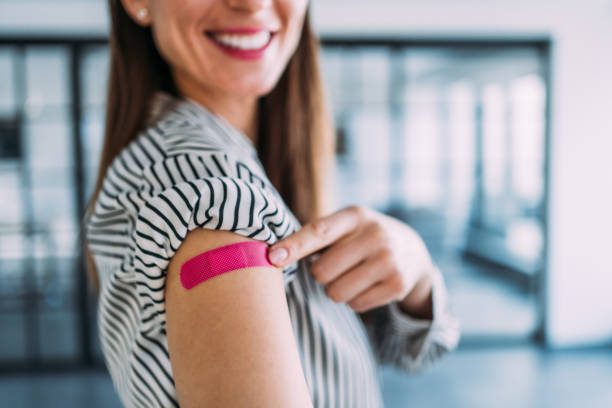 istock Woman showing her shoulder after getting vaccinated. 1366137671