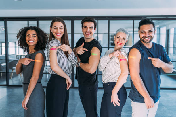 Friends showing their arms after getting vaccinated.